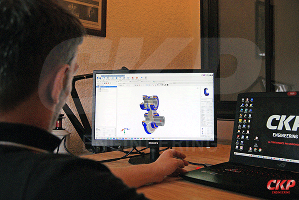 gros plan sur les mains d'un employé de TVI Groupe réglant une machine de fabrication industrielle